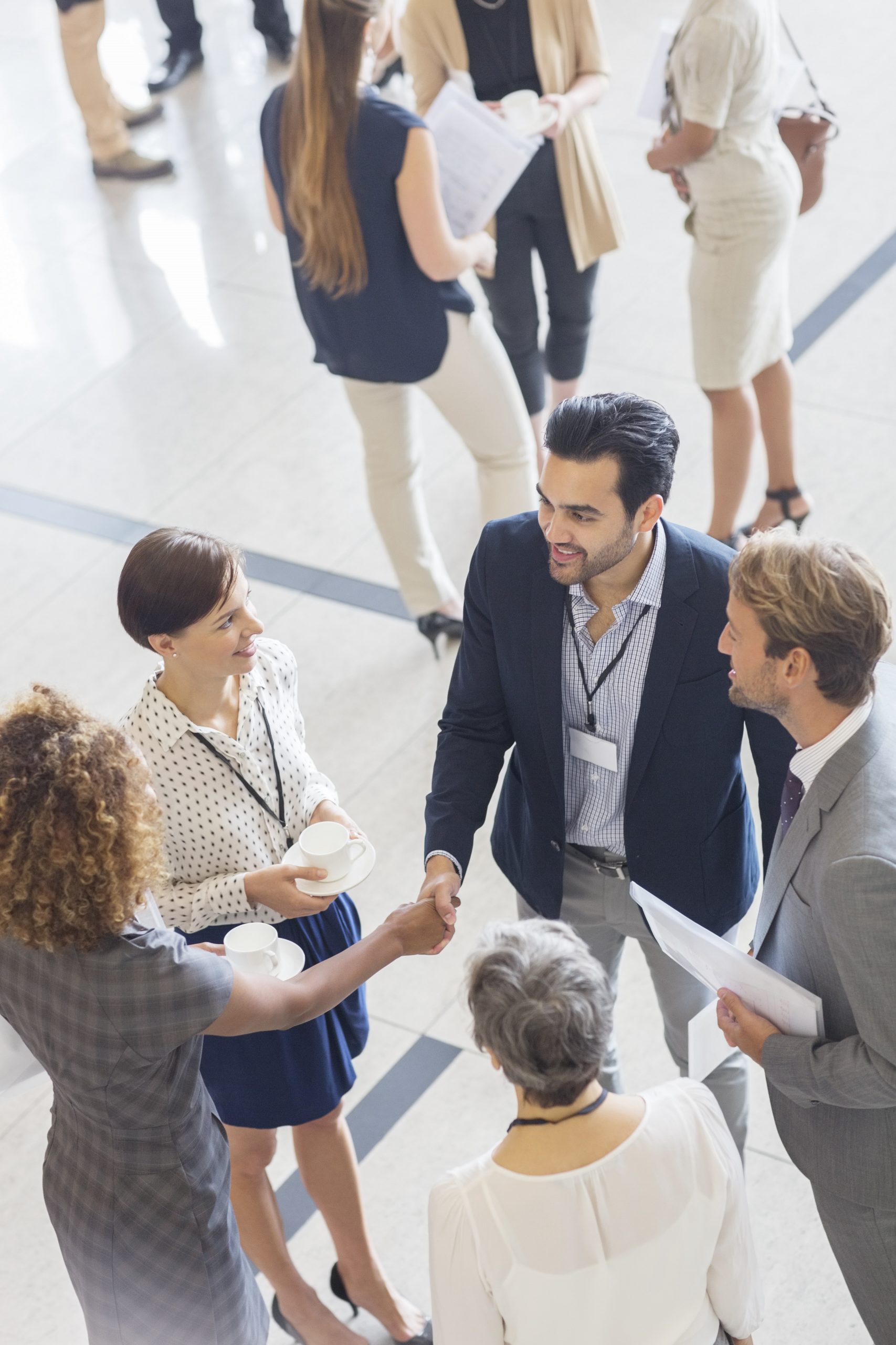 High angle view of group of business people shaking hands in office