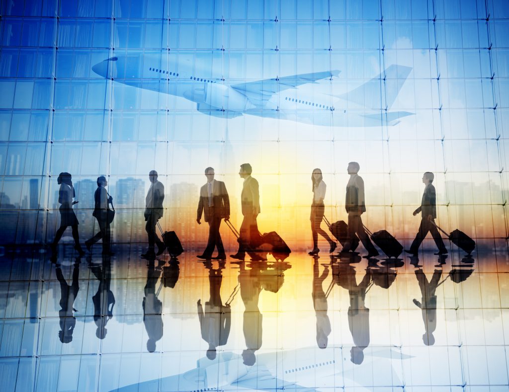 Group of Business Travellers Walking in an Airport